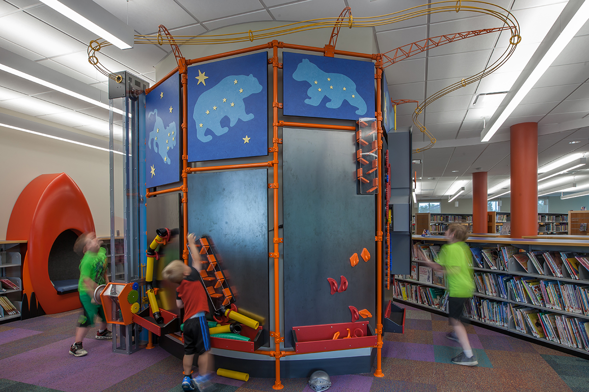 children playing with magnetic wall exhibits